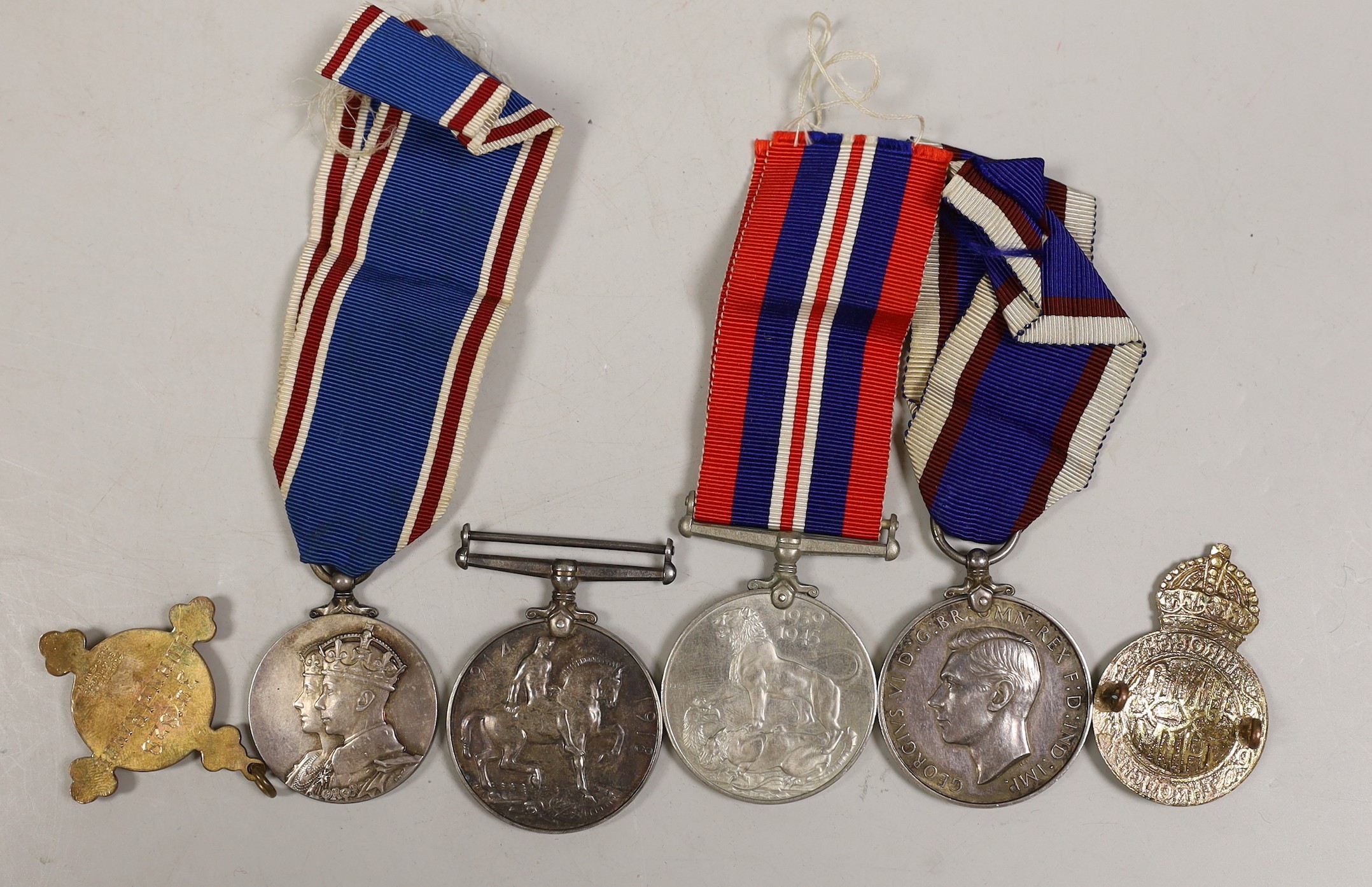 A George VI Royal Fleet Reserve medal, to J. 106331 (DEV. B. 16234) E. J. Shepherd. A.B. R.F.R., a George VI coronation medal, WWI war medal to 13995 CPL.J.L. Grover Duke of Corwall's Light Infantry and two badges